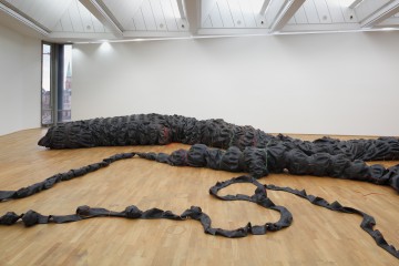 Nicholas Hlobo  b. 1975, South Africa Tyaphaka 2012 Rubber, ribbon, hose pipe, packaging material 400 x 50000 x 30 cm (157 1/2 x 19685 x 11 3/4 in.), dimensions variable Collection of the artist, courtesy Stevenson Gallery, Cape Town/Johannesburg