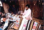 For this Tandroy funeral rite, the coffin is decorated with folded lengths of locally woven and commercially printed textiles.