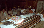 Throughout Madagascar, cloth is used to honor the dead and to show respect to revered ancestors. In this photograph, the coffin of a deceased Tanala elder is covered with a striped handwoven cloth during a mourning ceremony