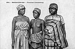 Zafimaniry women sporting reed hats and cloth wrappers woven from bark or raffia fiber
