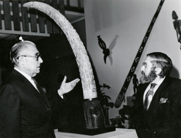 Collector Paul Tishman (left) and National Museum of African Art founding director Warren M. Robbins converse during the exhibition Sculpture of Black Africa, the Paul Tishman Collection at College of Fine Arts, University of Texas, Austin, 1971